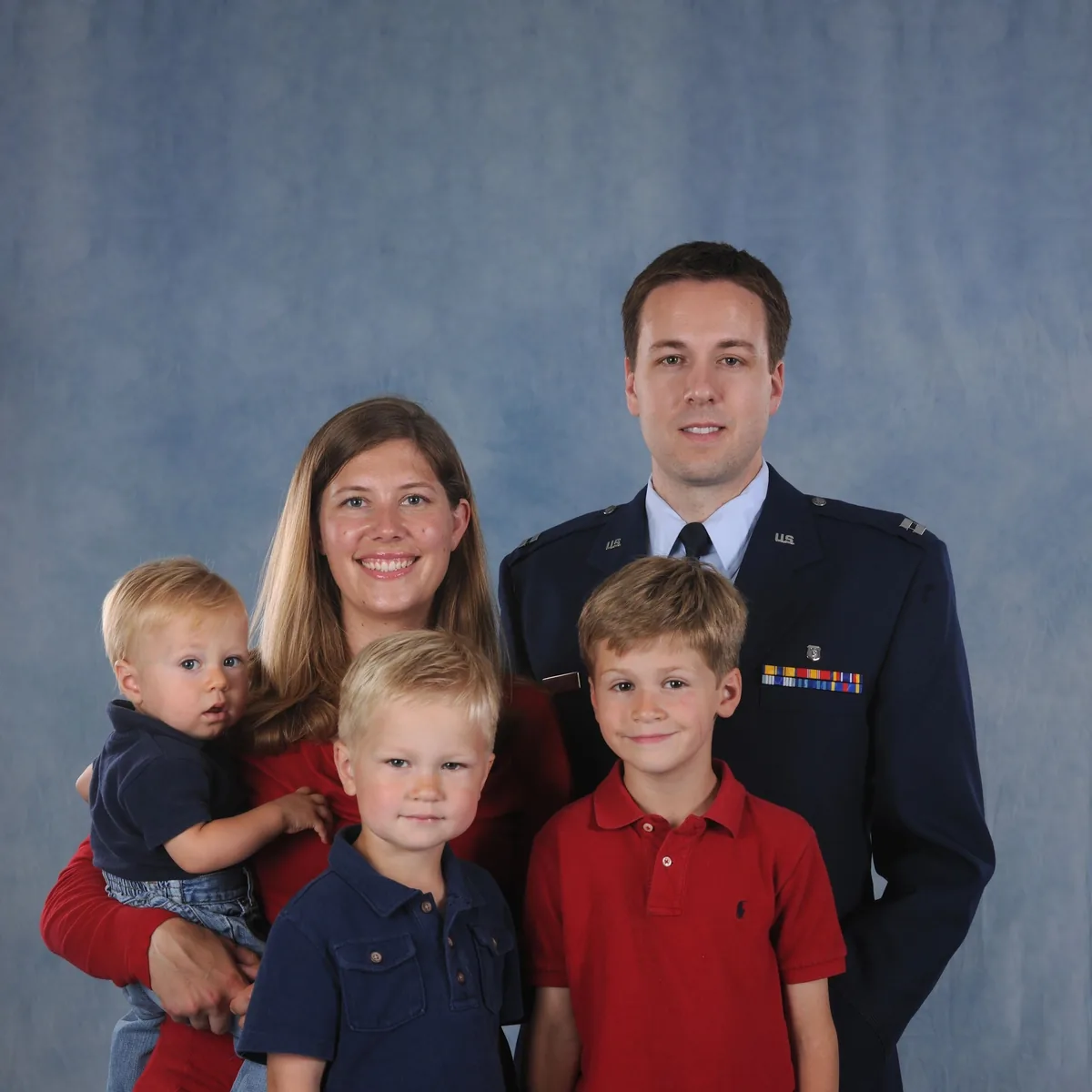 Dr. Smith in his U.S. Air Force uniform with his wife and their three sons.